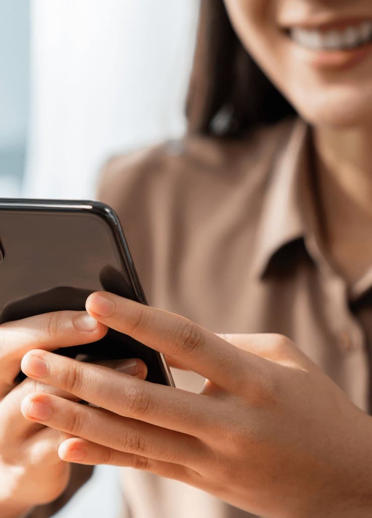 Person smiling while using a smartphone
