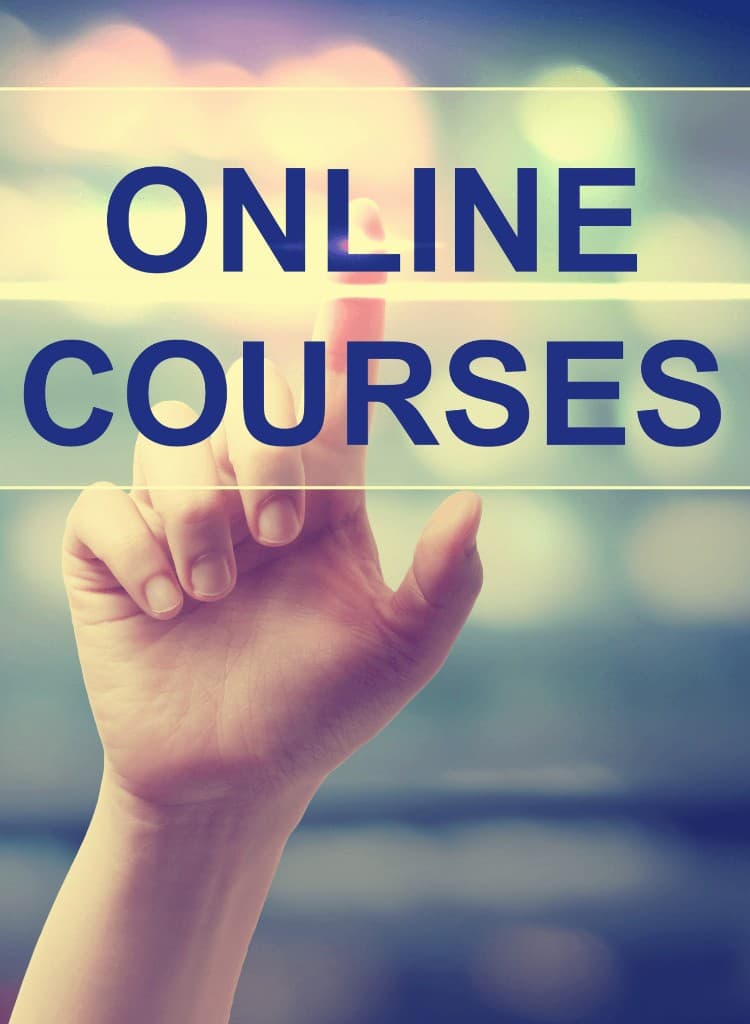 Hand reaching toward the words Online Courses
